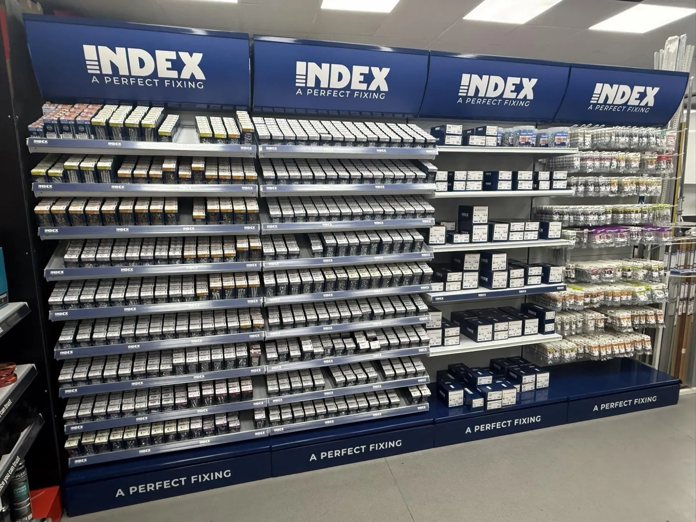 The Index fixings wall at Splash Out: four blue Index headers over racks of screws, bolts and boxed fixings.