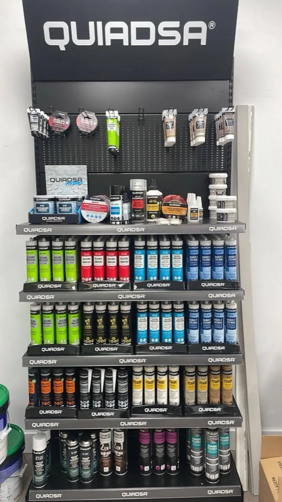 Rows of Quiadsa silicone and adhesive cartridges on the shelf.